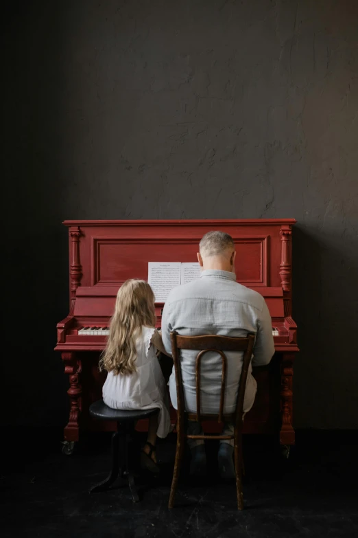 a man and a little girl sitting at a piano, pexels contest winner, red and grey only, paul barson, a blond, restored color