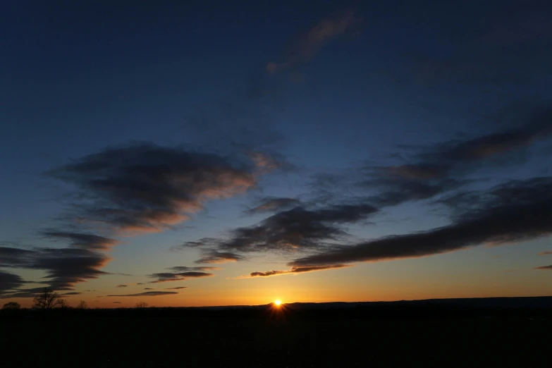 the sun is setting behind the clouds in the sky, by Ian Fairweather, cloudless-crear-sky, 2022 photograph, scenery, no cropping