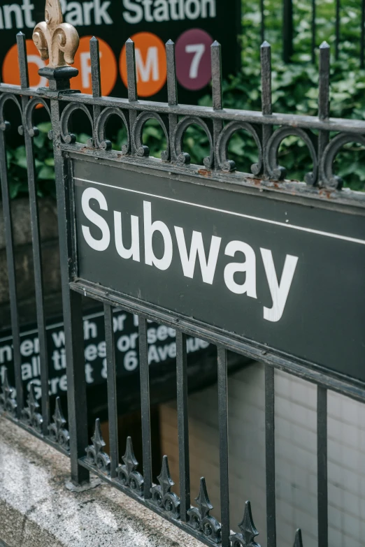 a black and white subway sign next to a fence, trending on unsplash, steel archways, ny, square, 🚿🗝📝