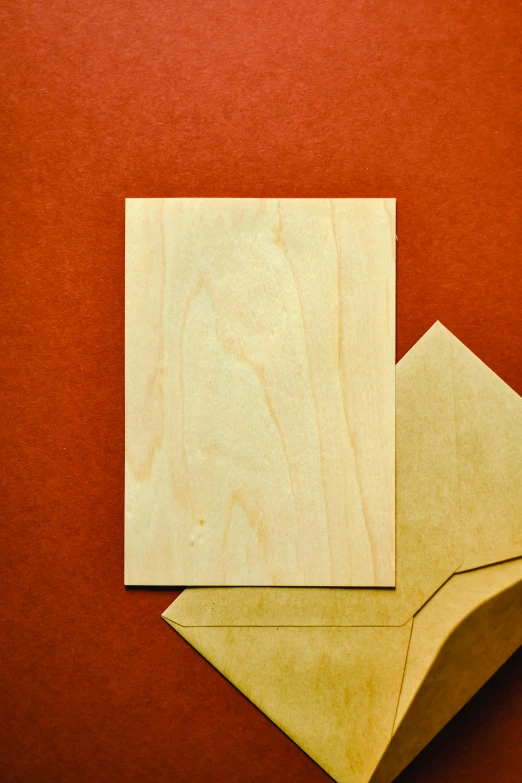 a piece of wood sitting on top of a piece of paper, whole card, arched back, detailed product image, single color