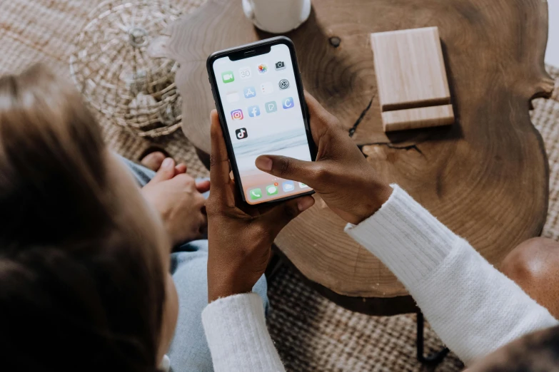 a woman sitting on a couch holding a cell phone, trending on pexels, ios app icon, a wooden, unsplash transparent, instagram post 4k