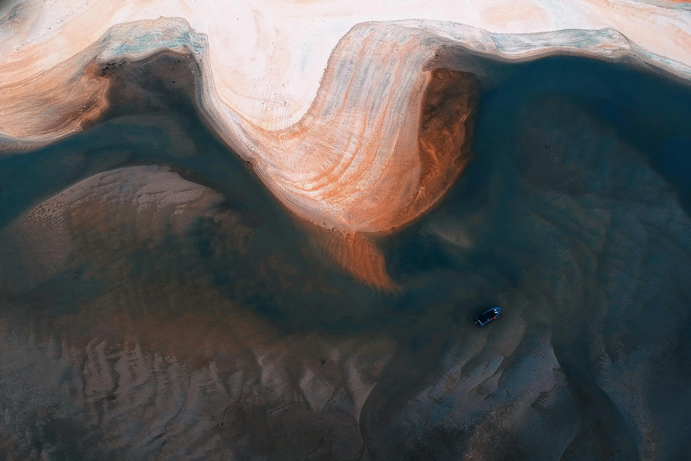 an aerial view of a large body of water, inspired by Filip Hodas, unsplash contest winner, huge bull emerging from the sand, ice cave, desert colors, an abstract
