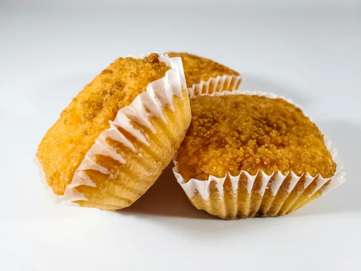 a couple of muffins sitting on top of each other, inspired by Chippy, unsplash, hurufiyya, deep fried, high quality product image”, background image, 3 - piece