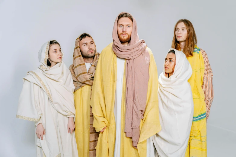 a group of people dressed in biblical clothing, an album cover, unsplash, yellow robe, 8k octan photo, easter, cast