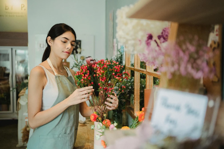 a woman standing in front of a bunch of flowers, pexels contest winner, arts and crafts movement, people at work, flower shop scene, avatar image, joanna gaines