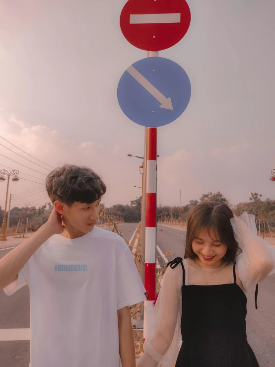 a couple of people standing next to a street sign, by Tan Ting-pho, trending on unsplash, male ulzzang, 🎀 🧟 🍓 🧚, cute pose, teenage no