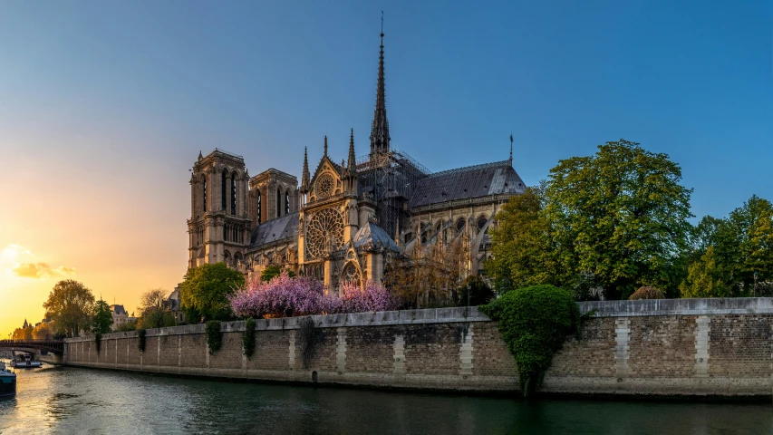 a large building sitting on the side of a river, by Theo Constanté, pexels contest winner, renaissance, cathedral, spring evening, joan of arc, les catacombes