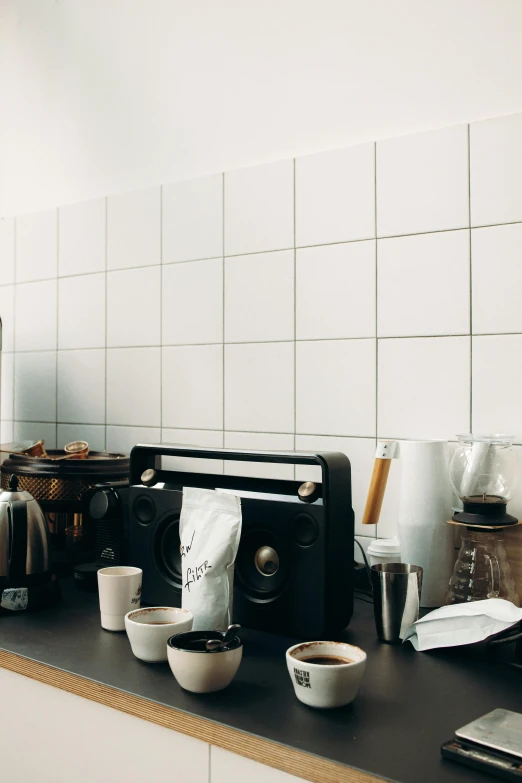 a coffee machine sitting on top of a kitchen counter, a still life, by Andries Stock, unsplash, made of all white ceramic tiles, panorama, dwell, set photo