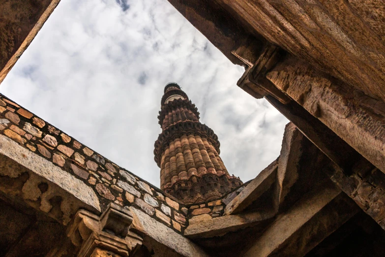 a very tall tower sitting in the middle of a building, ancient india, fan favorite, promo image, fallen columns