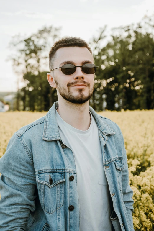 a man standing in a field of yellow flowers, a picture, inspired by Dan Smith, aestheticism, looking smug, discord profile picture, wearing casual clothing, wearing shades