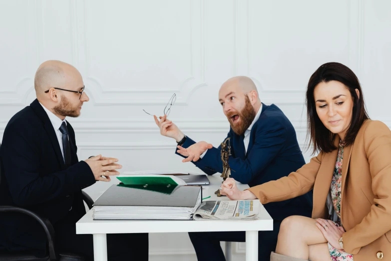 a group of people sitting around a table, lawyer clothing, frustration, te pae, 2019 trending photo