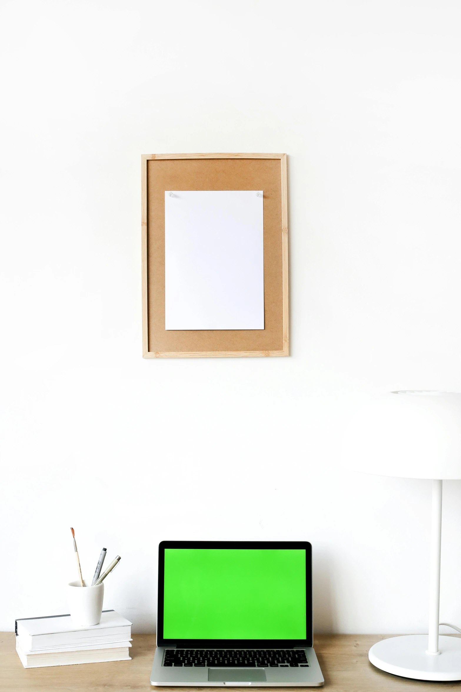 a laptop computer sitting on top of a wooden desk, poster art, card frame, green and white, white background wall, clipboard