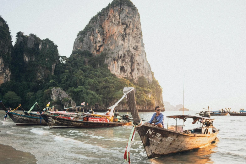 a couple of boats that are sitting in the water, inspired by Steve McCurry, pexels contest winner, in style of thawan duchanee, late summer evening, 70s photo, tourist destination