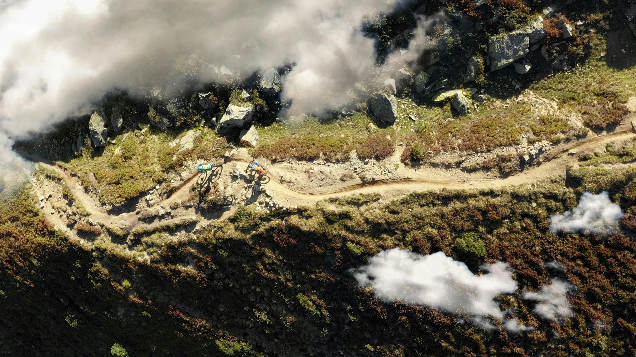 smoke billowing out from the top of a mountain, a detailed matte painting, inspired by Filip Hodas, pexels contest winner, photorealism, rocky ground with a dirt path, riding, photograph from above, new zealand