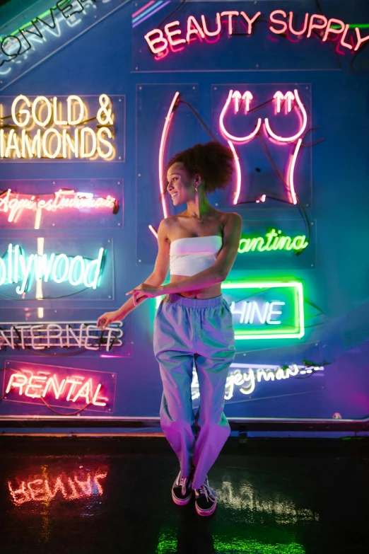 a woman standing in front of a neon sign, inspired by David LaChapelle, trending on pexels, nathalie emmanuel, ariana grande, gold hour, iridescent tubes