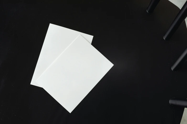 a white piece of paper sitting on top of a black table