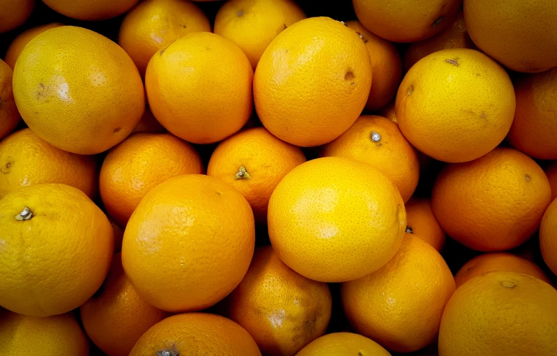 a pile of oranges sitting on top of each other, by David Simpson, pexels, yellow, unedited, 🐿🍸🍋