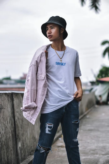 a man standing on a sidewalk wearing a hat, a picture, unsplash, jeans and t shirt, tomboy, pastel', studio ghibly style