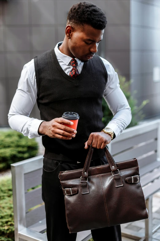 a man standing next to a bench holding a cup of coffee, suit vest, holding a leather purse, dark skin tone, cold brew coffee )