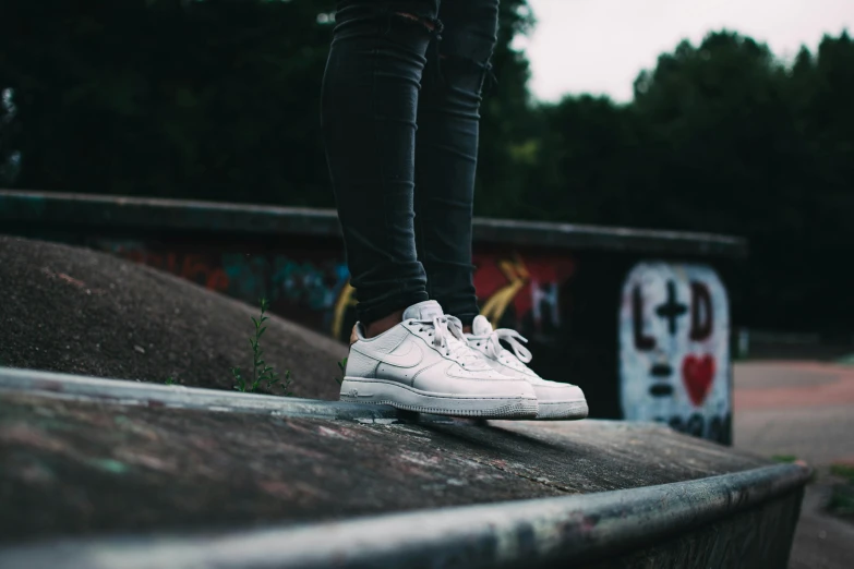 a person standing on top of a skateboard ramp, pexels contest winner, graffiti, wearing white sneakers, teenage girl, subtle details, air force