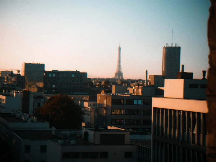 a view of the eiffel tower from a window, pexels contest winner, paris school, lo-fi art, skyline view from a rooftop, (golden hour), white buildings