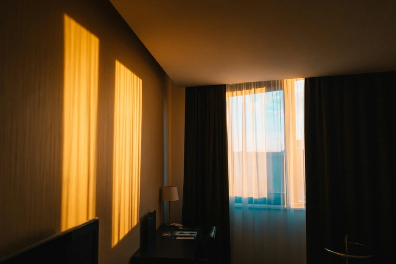 a bed room with a neatly made bed and a large window, inspired by Elsa Bleda, pexels contest winner, sun shafts, shadow gradient, hotel room, curtain