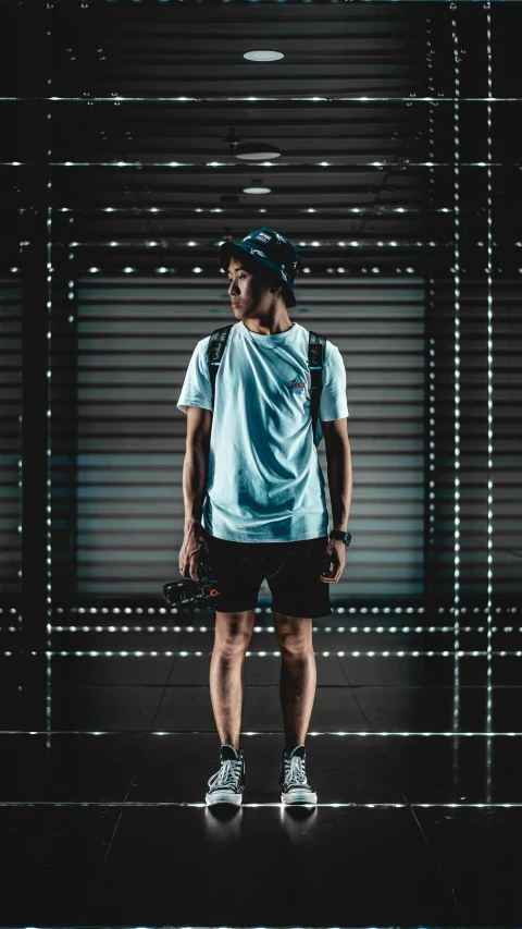 a man standing in front of a metal door, inspired by Rudy Siswanto, unsplash contest winner, wearing a light blue shirt, mocap, sporty, outfit photo