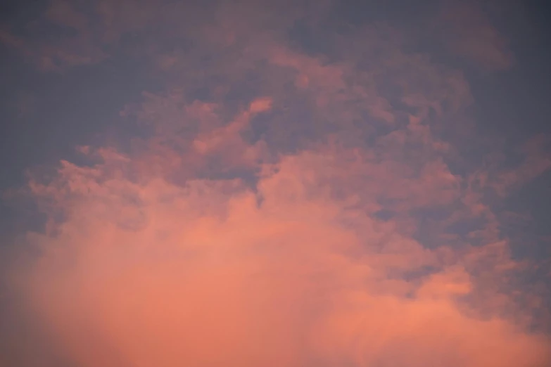 there is a plane that is flying in the sky, by Attila Meszlenyi, unsplash, aestheticism, soft light 4 k in pink, red cloud light, humid evening, sky is orangish outside