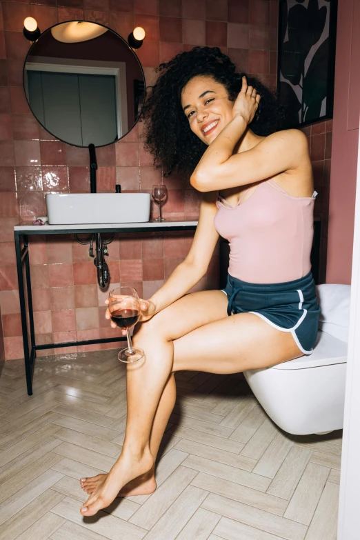 a woman sitting on a toilet in a bathroom, trending on unsplash, renaissance, enjoying a glass of wine, mixed-race woman, playful pose, uncropped