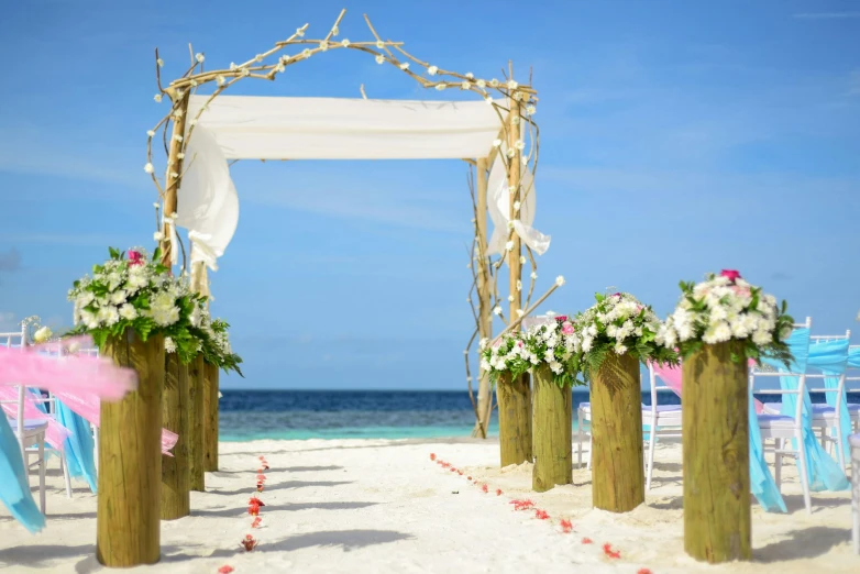 a wedding ceremony set up on the beach, unsplash, sunny sky, archway, holiday season, white