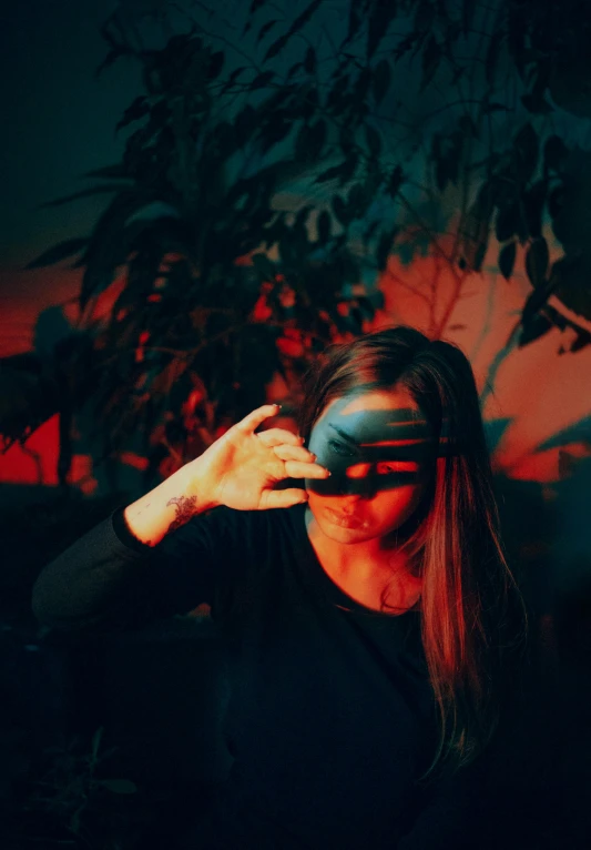 a woman with a blindfold covering her eyes, a picture, inspired by Elsa Bleda, unsplash contest winner, vhs effect, light red and deep blue mood, reflection of iphone in visor, emanating magic from her palms