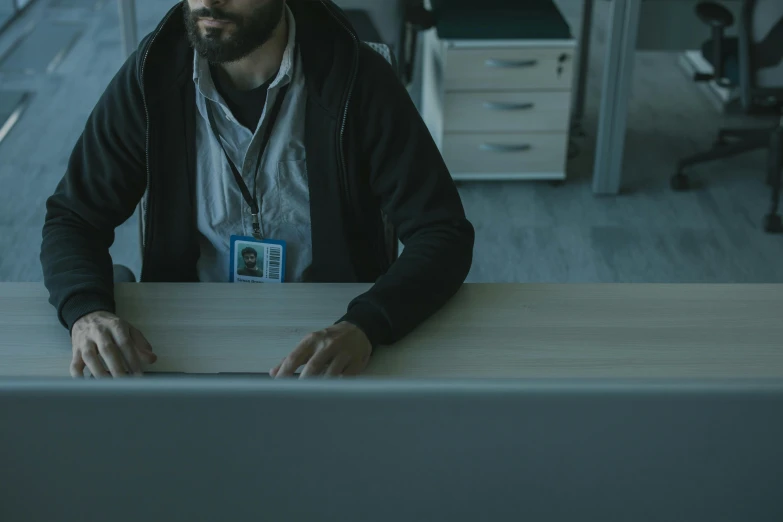 a man sitting at a desk using a laptop computer, pexels contest winner, mystery horror, worksafe. cinematic, office clothes, avatar image