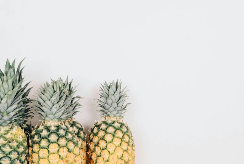 three pineapples sitting next to each other on a white surface, by Emma Andijewska, trending on unsplash, minimalism, adult pair of twins, 🦩🪐🐞👩🏻🦳, gif, background image