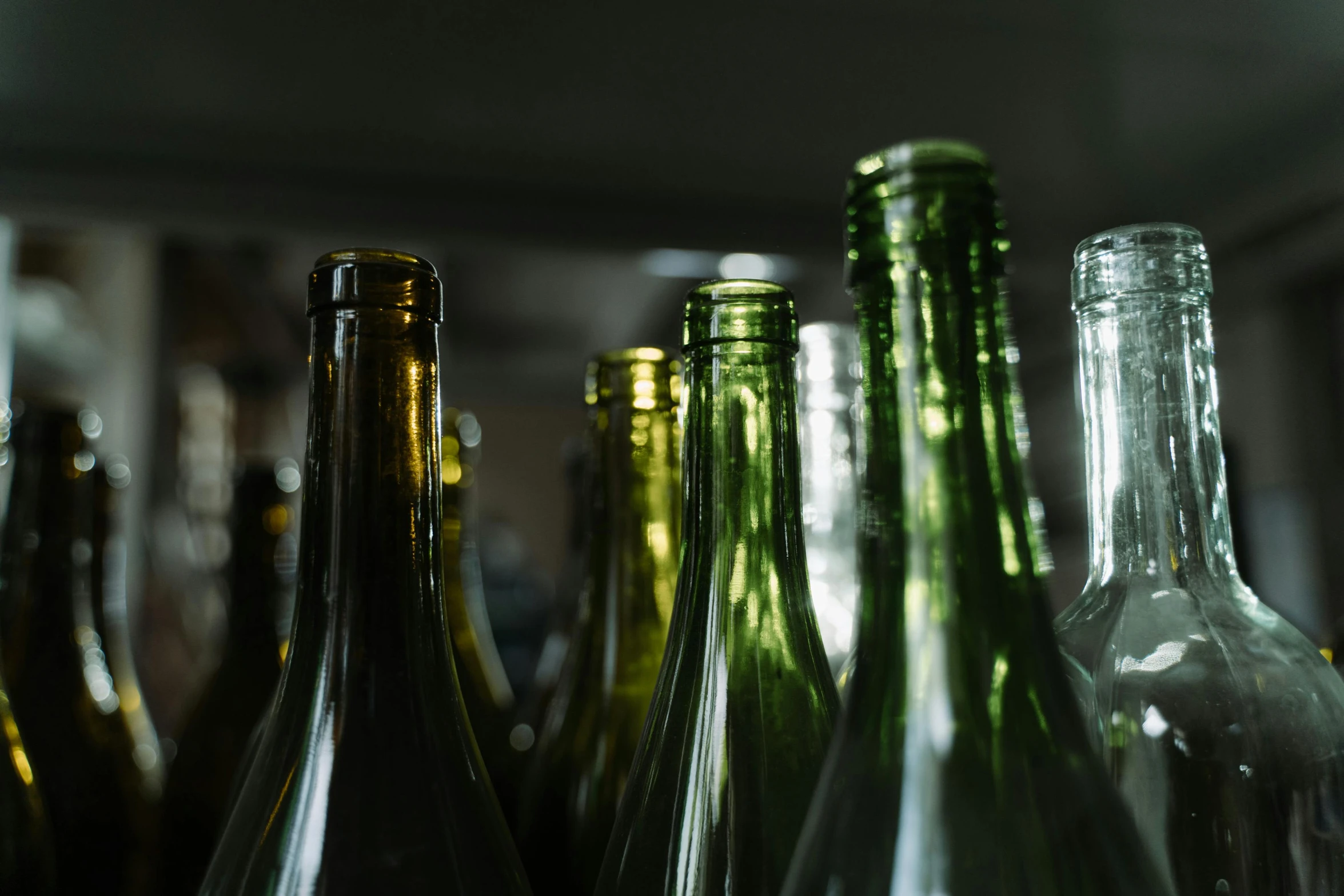 a bunch of bottles sitting on top of a table, pexels, glass openings, medium close up, understated, cellar