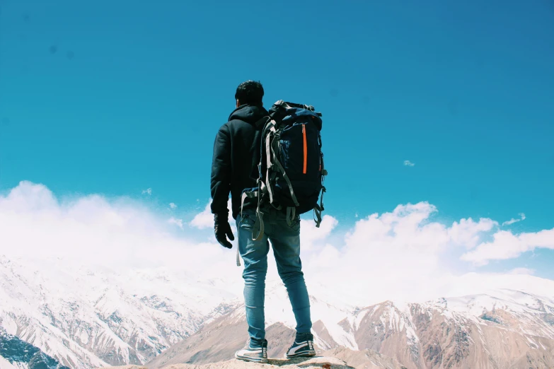 a man standing on top of a mountain with a backpack, pexels contest winner, wearing cargo pants, avatar image, thumbnail, cold
