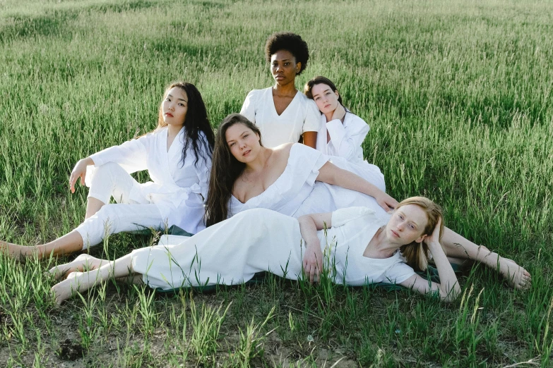 a group of women sitting on top of a lush green field, inspired by Vanessa Beecroft, unsplash, renaissance, wearing white pajamas, portrait image