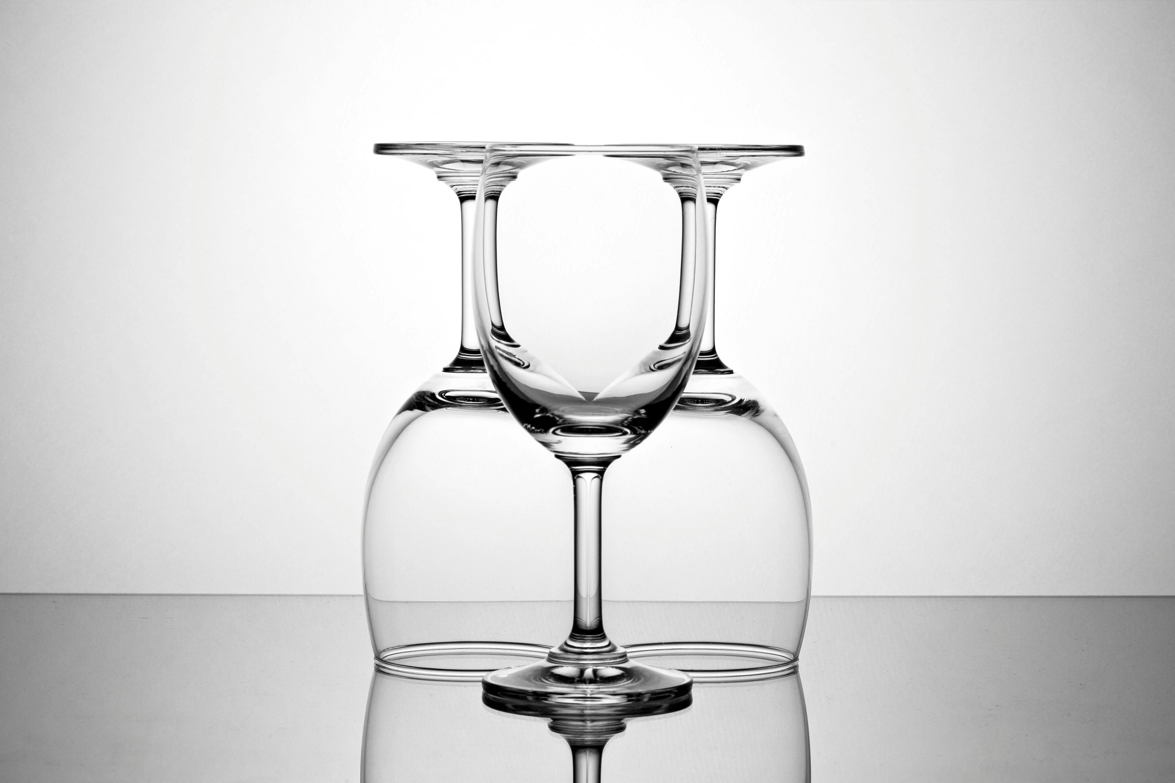 a couple of wine glasses sitting on top of a table, by Jan Rustem, minimalism, 360 monoscopic equirectangular, commercial product photography, underside, siamese twins