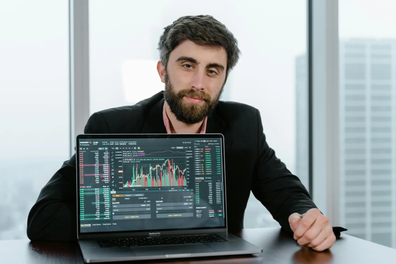 a man sitting in front of a laptop computer, a picture, by Adam Marczyński, pexels contest winner, displaying stock charts, daniel oxford, portrait shot 8 k, official screenshot