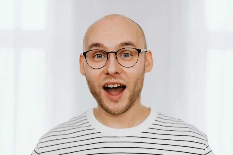 a man with a surprised look on his face, inspired by Leo Leuppi, pexels contest winner, antipodeans, no hair completely bald, nerdy appearance, avatar image, excited