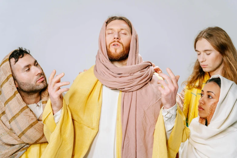 a group of people dressed as jesus and mary, an album cover, inspired by Richard Dadd, unsplash, yellow robe, aphex twin, high quality photo, h3h3