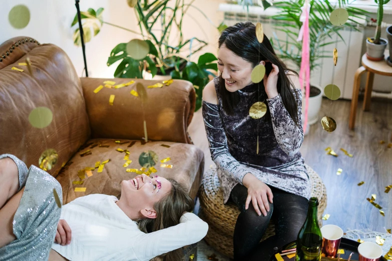 a couple of women sitting on top of a couch, pexels contest winner, happening, confetti, ruan jia and mandy jurgens, with ivy, manuka