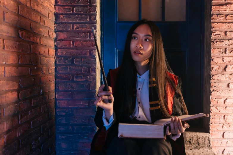 a woman holding a book and a pair of scissors, a portrait, inspired by Hermione Hammond, pexels contest winner, mahira khan as a d&d wizard, hogwarts stairwell, gemma chen, ( ( theatrical ) )
