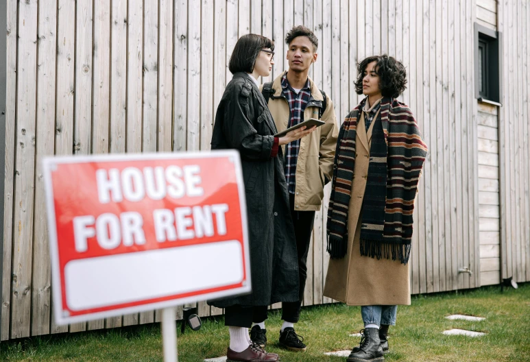 three people standing in front of a house for rent sign, by Carey Morris, wearing a grey robe, gen z, gemma chen, hunting