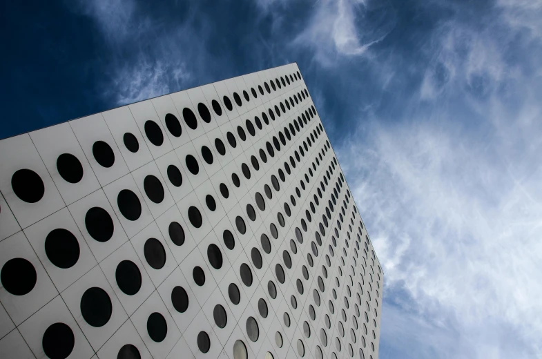 a very tall building with a lot of holes on it, inspired by Bauhaus, unsplash, minimalism, fan favorite, square, cumulus, zaha hadid building