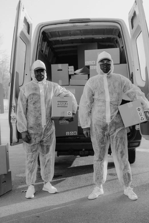 a couple of men standing next to a van, by Dean Ellis, staff wearing hazmat suits, bw, 1996)