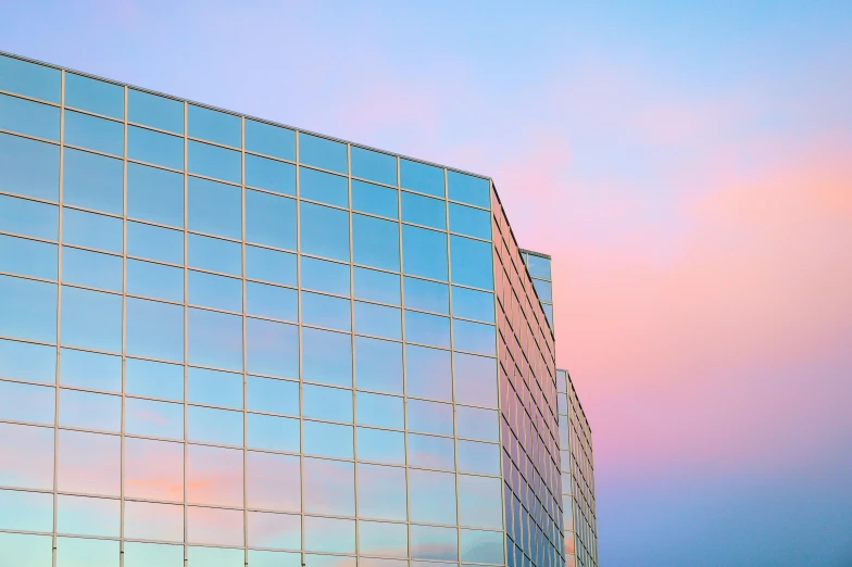 a very tall building with a lot of windows, an album cover, unsplash, modernism, pastel sunset, southdale center, square lines, “puffy cloudscape