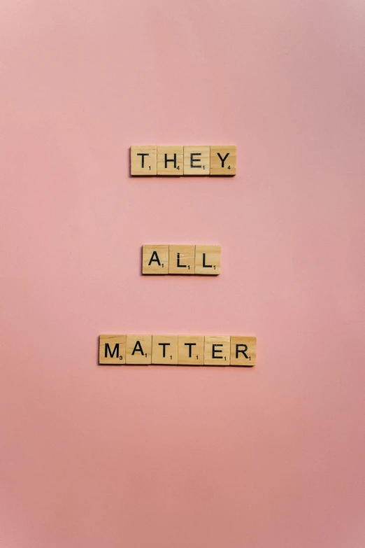 scrabbles spelling they all matter on a pink background, an album cover, by Alison Geissler, trending on unsplash, society 6, thy, 2 0 2 2 photo, panel