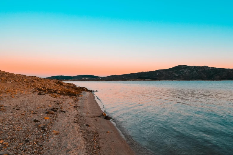 a sandy beach next to a body of water, pexels contest winner, orange and blue tones, summer evening, greece, pink white turquoise