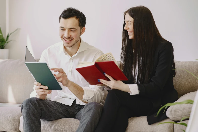 a man and a woman sitting on a couch reading books, pexels contest winner, office clothes, avatar image, slight nerdy smile, academic clothing