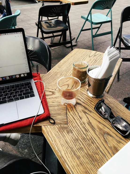 a laptop computer sitting on top of a wooden table, by Carey Morris, happening, in a sidewalk cafe, cold brew coffee ), imgur, studious